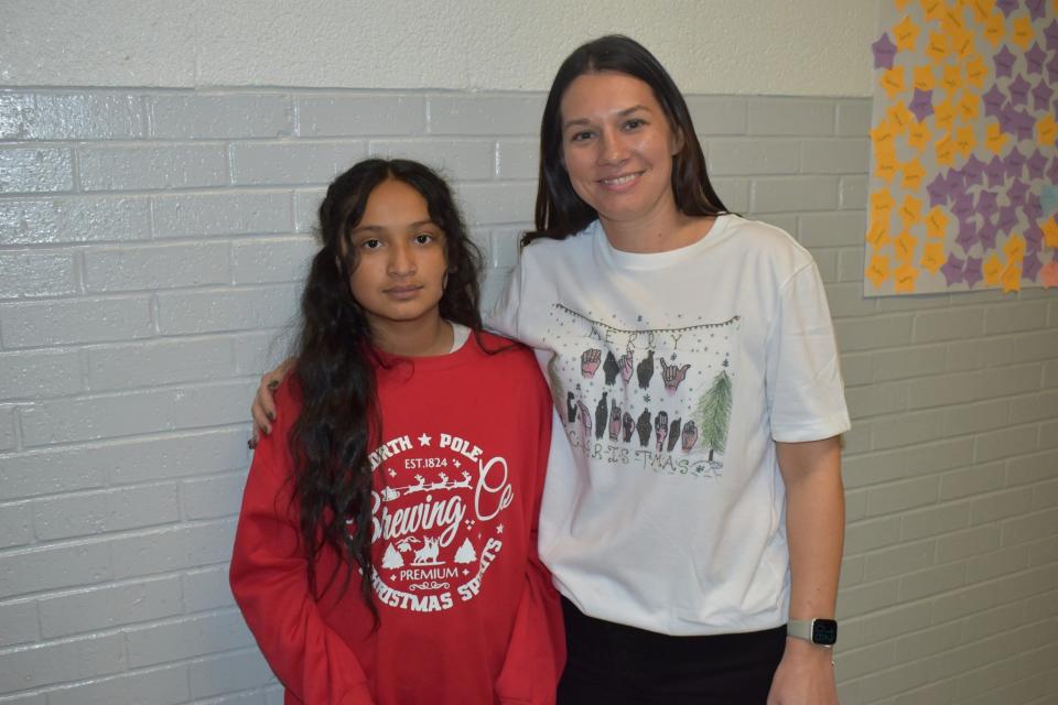 Cunningham Elementary School fifth-grader Giselle Fernandez, left, shown here with Cunningham teacher Michelle Clark, created the winning artwork for this year's Wichita Falls ISD Christmas card design.
