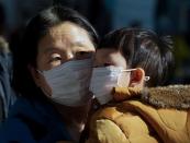 A mother and her child wear a mask to prevent contacting a new coronavirus in Seoul