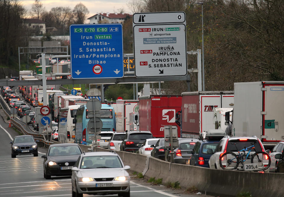 Demonstrators block the highway near the French border with Spain, during a protest in Biriatou, southwestern France, Saturday, Dec. 22, 2018. The yellow vest protests, which have brought chaos to Paris over the past few weeks, clearly abated Saturday as the Christmas holiday season began in earnest. Outside Paris, around 200 roundabouts remained occupied across the country. In southern France near the Spanish border, dozens of demonstrators blocked trucks and chanted "Macron, Demission," which translates as "Macron, resign."(AP Photo/Bob Edme)