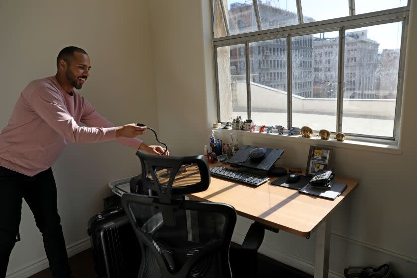 LOS ANGELES, CA - FEBRUARY 15: Stephen Jackson, 31, recently purchased a two bedroom, one bath, 840sqft loft at Shybary Grand Lofts located at 312 W. 5th Street and Broadway in downtown on Wednesday, Feb. 15, 2023 in Los Angeles, CA. Jackson is shown in one of the bedrooms he uses as an office. The Shybary building was built in 1923. (Gary Coronado / Los Angeles Times)