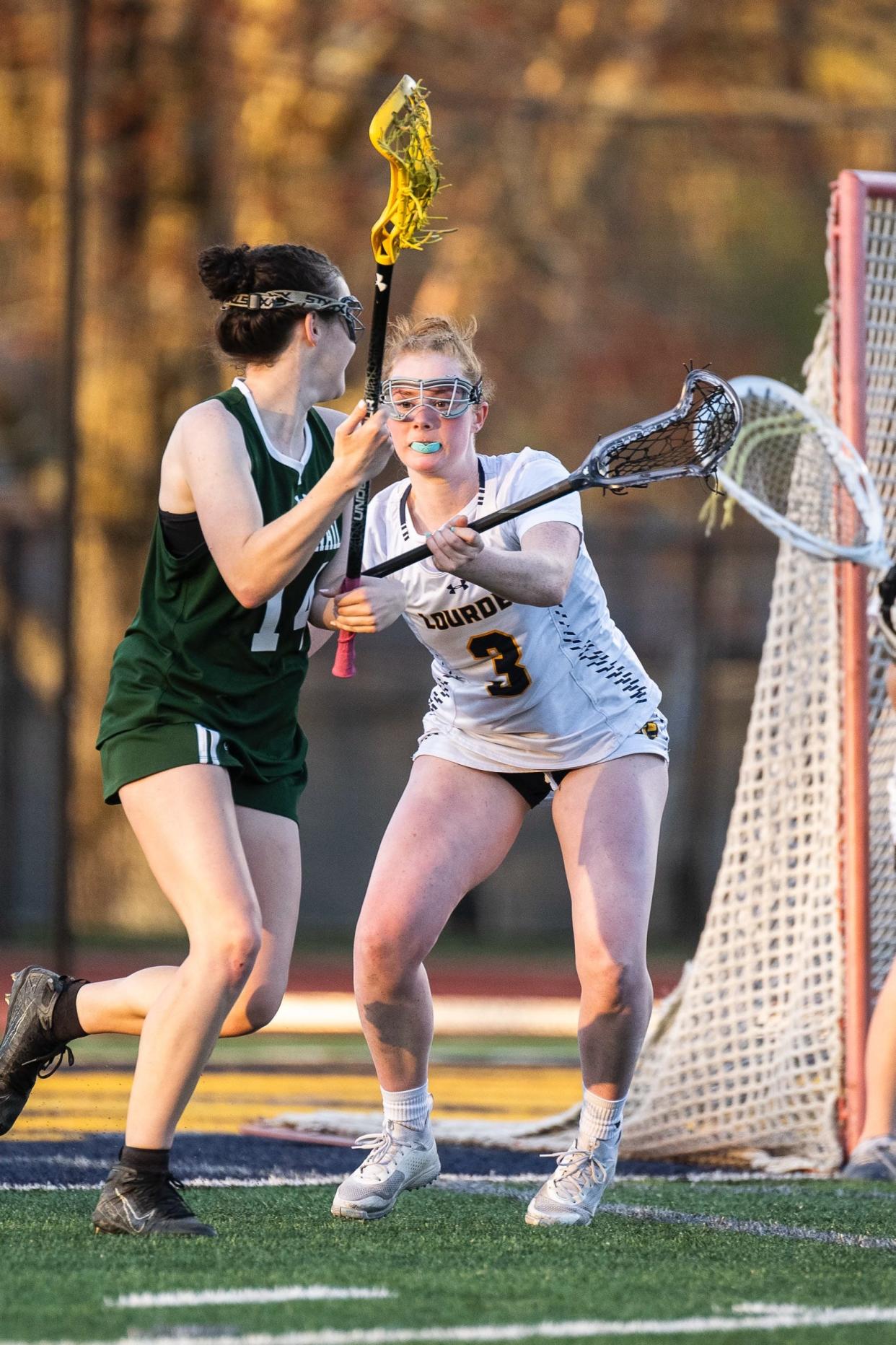 Lourdes' Abby Anderson covers a Cornwall player attempting to attack the goal during an April 26, 2024 girls lacrosse match.