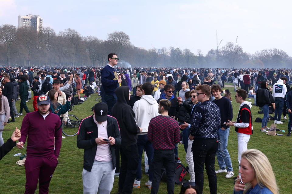 People gather and smoke during a demonstration to mark the informal cannabis holiday, 4/20, in Hyde Park, London, Britain, April 20, 2021. REUTERS/Tom Nicholson