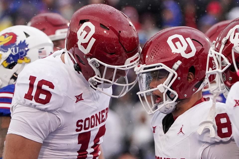 Oklahoma Sooners quarterback Dillon Gabriel celebrates with tight end Blake Smith after Gabriel score against the Kansas Jayhawks at David Booth Kansas Memorial Stadium.