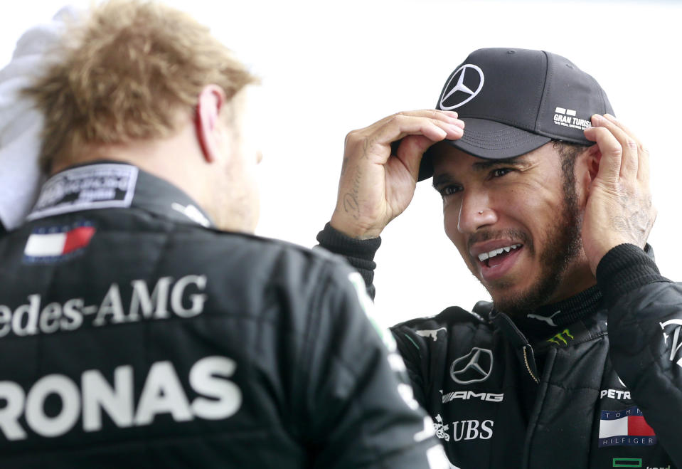 Race winner Mercedes driver Lewis Hamilton of Britain, right, speaks with second placed Mercedes driver Valtteri Bottas of Finland after the Formula One Grand Prix at the Spa-Francorchamps racetrack in Spa, Belgium, Sunday, Aug. 30, 2020. (Stephanie Lecocq, Pool via AP)