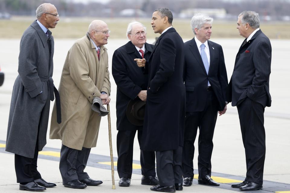 President Barack Obama and Transportation Secretary Ray LaHood, right, are met by, from left: Detroit Mayor Dave Bing; Rep. John Dingell, D-Mich.; Sen. Carl Levin, D-Mich., and Michigan Gov. Rick Snyder, after stepping off Air Force One upon his arrival at  Metropolitan Wayne County Airport in Detroit, Monday, Dec. 10, 2012, before going to the Daimler Detroit Diesel plant in Redford, Mich.