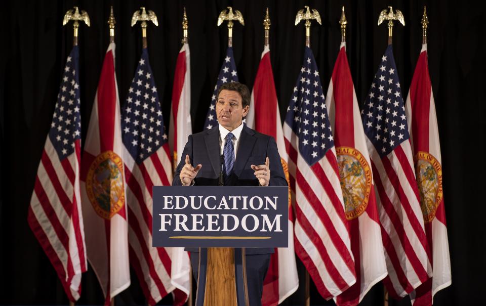 Florida Governor Ron DeSantis answers questions from the media during a press conference at Christopher Columbus High School on Monday, March 27, 2023, in Miami, Fla. The press conference was held to announce DeSantis's signing of a private school voucher expansion, HB1, which allows more Florida school children become eligible for taxpayer-funded school vouchers.(Matias J. Ocner/Miami Herald via AP)