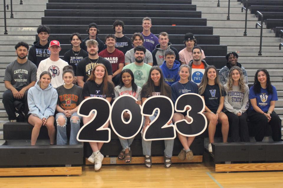 Twenty five of Taunton High School's senior student-athletes committed to compete at the collegiate level pose with a "2023" sign during a photo op at the Rabouin Field House on May 31, 2023.