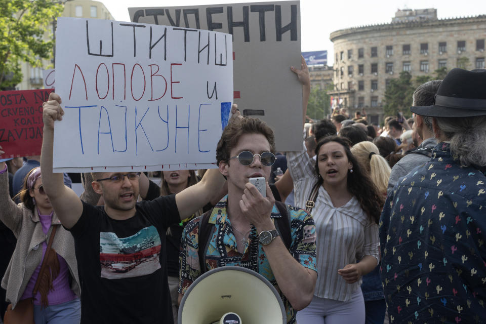 University students attend a protest in Belgrade, Serbia, Saturday, June 3, 2023. Tens of thousands of people rallied in Serbia's capital on Saturday in protest of the government's handling of a crisis after two mass shootings in the Balkan country. Banner reads "You are protecting thieves and tycoons" in Serbian Cyrillic letters. (AP Photo/Marko Drobnjakovic)