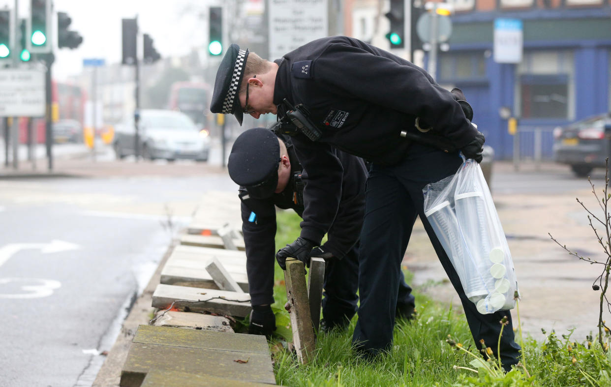 Police officers look for hidden weapons in London (PA)