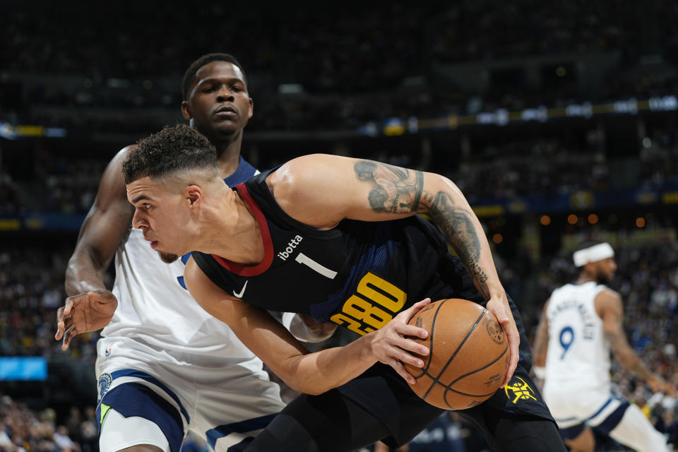 Denver Nuggets forward Michael Porter Jr., front, is defended by Minnesota Timberwolves guard Anthony Edwards during the first half of Game 5 of an NBA basketball second-round playoff series Tuesday, May 14, 2024, in Denver (AP Photo/David Zalubowski)