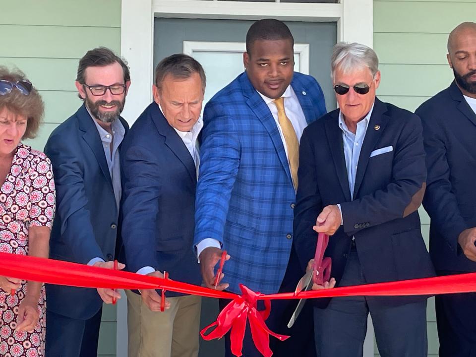 Lockport Mayor Paul Champagne and other officials cut the ribbon Wednesday to ceremoniously open Les Maisons de Bayou Lafourche.