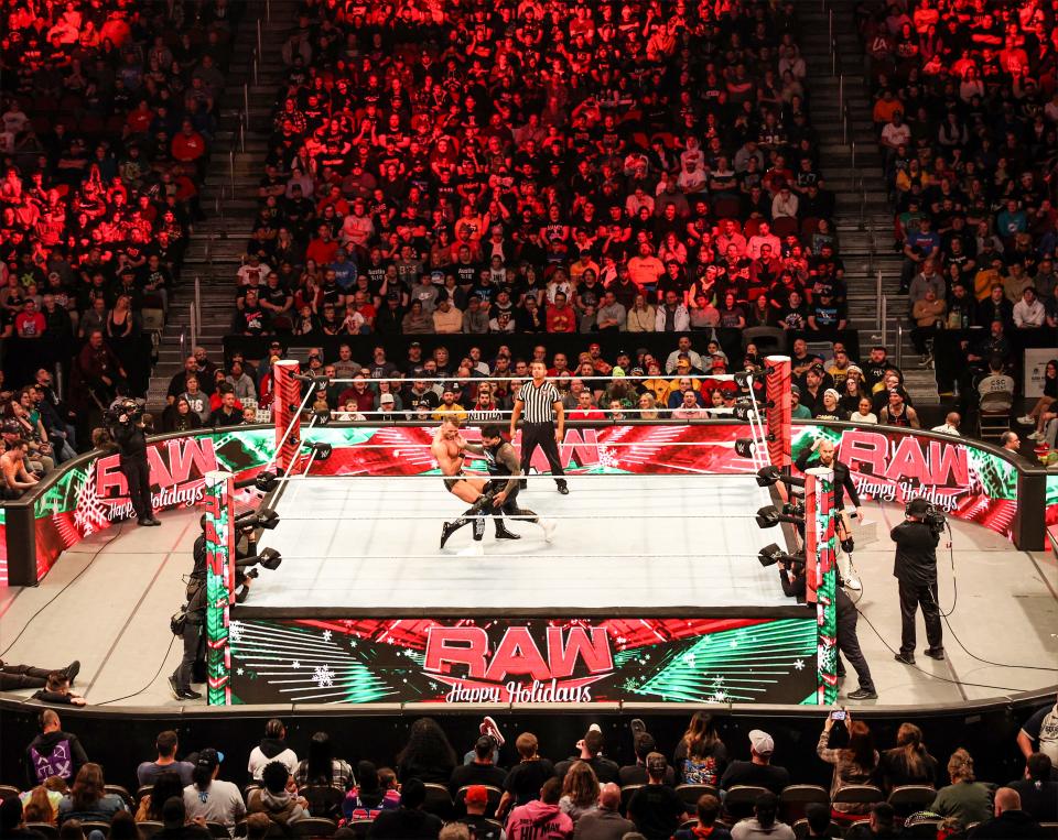 Fans watch the excitement of "WWE Monday Night Raw" at Wells Fargo Arena in Des Moines.