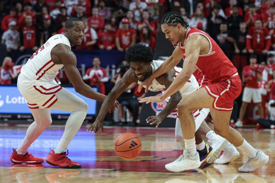 Nov 10, 2023; Piscataway, New Jersey, USA; Rutgers Scarlet Knights guard Austin Williams (24) and forward Aundre Hyatt (5) battle Boston University Terriers forward Matai Baptiste (0) for the ball during the first half at Jersey Mike's Arena.