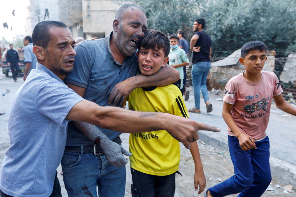 A Palestinian man is assisted after being wounded in Israeli strikes in Rafah.
