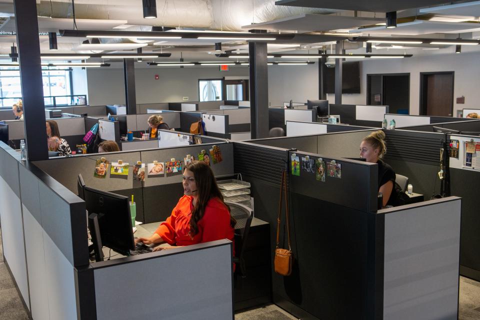 Advisors Excel employees work in cubicles inside the new Professional Building at 4125 SW Gage Center Drive Tuesday morning.