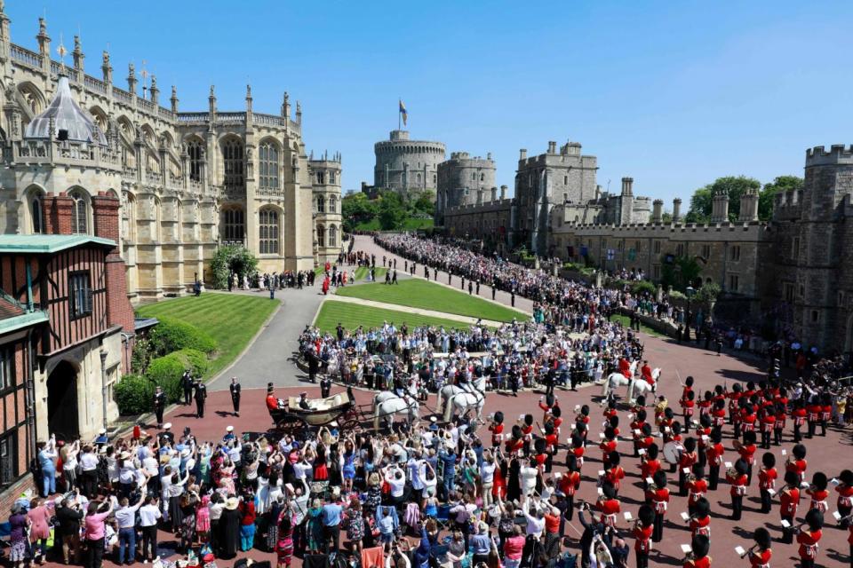 The royal couple as they made their procession around Windsor (AFP/Getty Images)