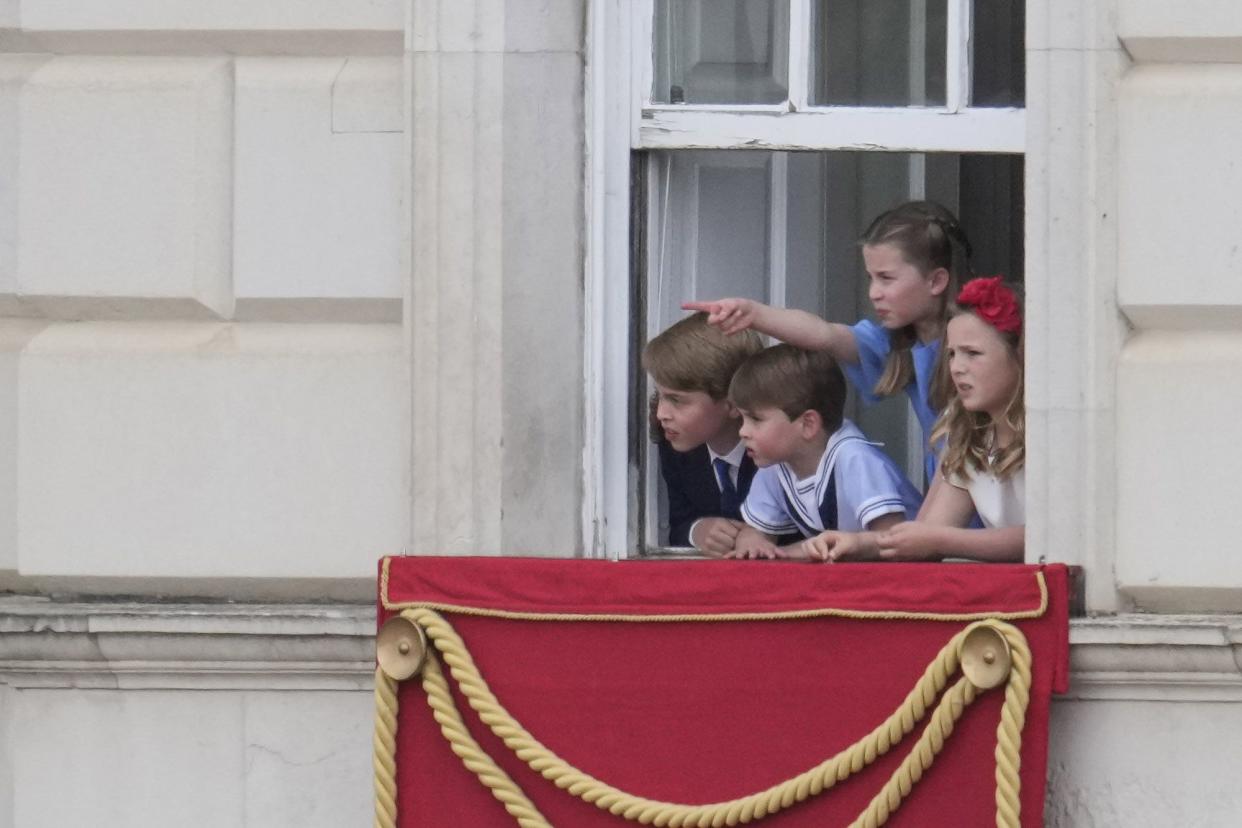 Prince George, Prince Louis and Princess Charlotte are seen looking out the window during Trooping The Colour on June 2, 2022, in London, England.