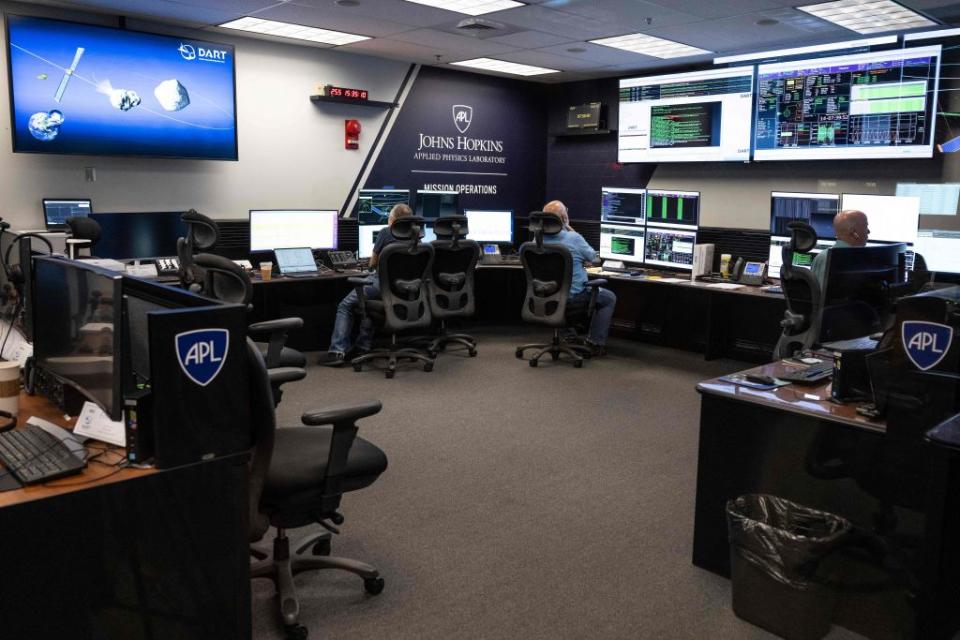 People sit at their workstations within the Mission Operations Center during the Double Asteroid Redirection Test (DART) Technology Media Workshop Telecon Briefing and tour at the Johns Hopkins Applied Physics Laboratory in Laurel, Maryland, on Sept. 12, 2022.<span class="copyright">JIM WATSON/AFP— Getty Images</span>