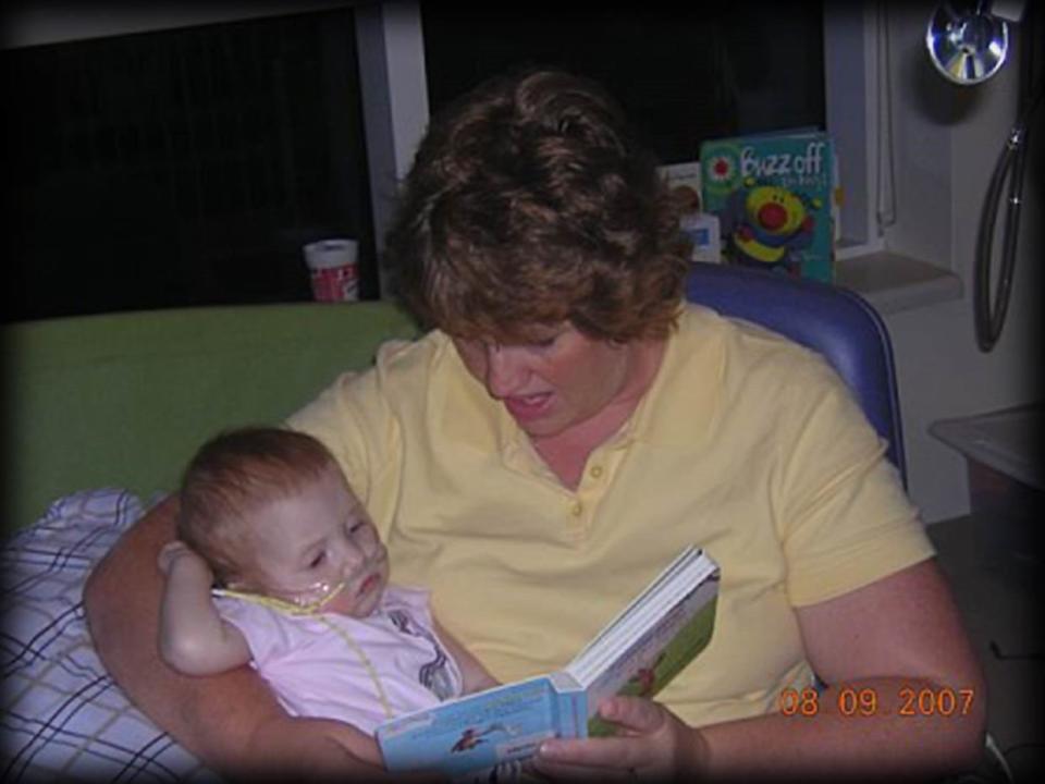 Krista Layman reads to her daughter, Kate Layman, while in Kate’s hospital room. The organization, Kate’s Kart, was named after Kate and gives books to children in the hospital, and anyone can donate to the cause at kateskart.org.