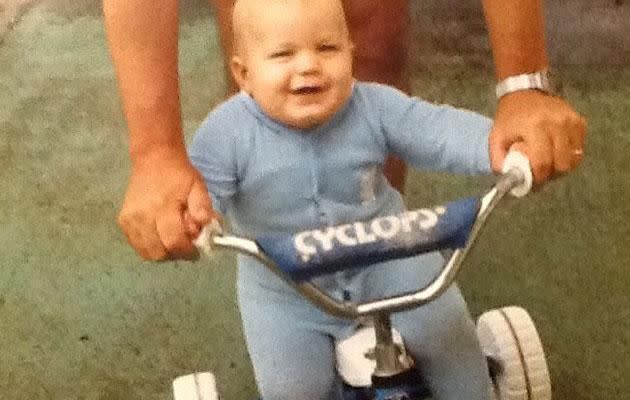 Nic on a tricycle as a baby.