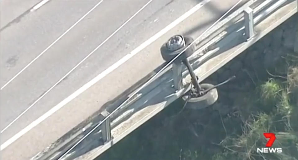 The vehicle hit with such force that an axle and two wheels were left hanging on the bridge barrier. Source: 7 News