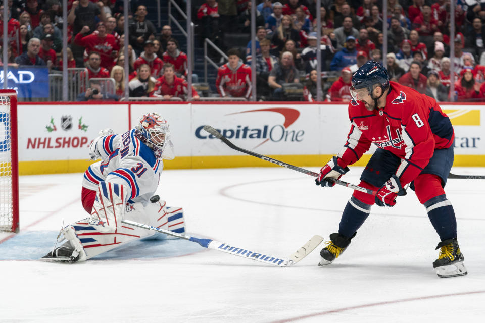 New York Rangers goaltender Igor Shesterkin (31) makes a save against Washington Capitals left wing Alex Ovechkin (8) during the first period of an NHL hockey game, Saturday, Dec. 9, 2023, in Washington. (AP Photo/Stephanie Scarbrough)