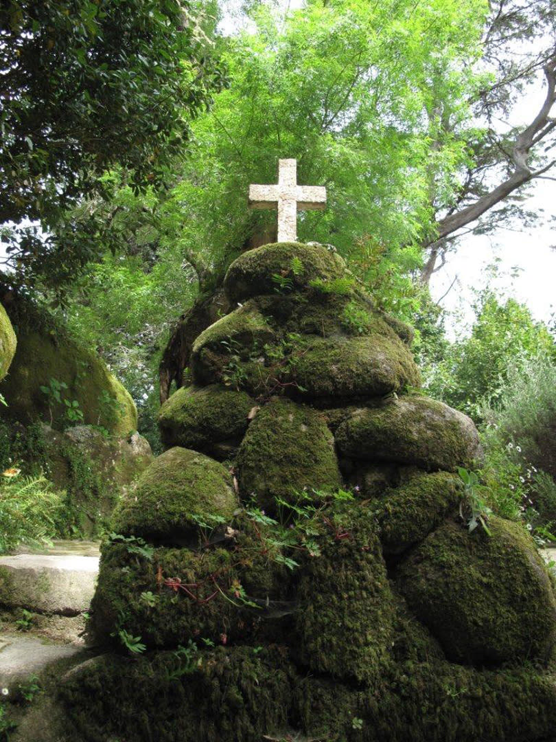 A simple cross marks the entrance to the Capuchos Convent, a monastery in Sintra, Portugal. Sintra has long been a playground of royalty near the Portuguese capital of Lisbon. Sintra is known for its spectacular palaces and other buildings, but several structures _ including the convent _ are notable for their pared-back simplicity. (AP Photo/Mike Corder)