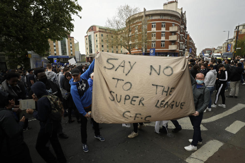 FILE - Chelsea fans protest outside Stamford Bridge stadium in London, against Chelsea's then decision to be included amongst the clubs attempting to form a new European Super League, Tuesday, April 20, 2021. The European Union’s top court has ruled UEFA and FIFA acted contrary to competition law by blocking plans for the breakaway Super League. The case was heard last year at the Court of Justice after Super League failed at launch in April 2021. UEFA President Aleksander Ceferin called the club leaders “snakes” and “liars.” (AP Photo/Matt Dunham, File)