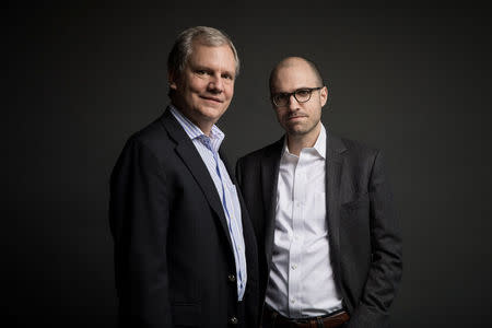 The incoming publisher of the New York Times Arthur Gregg (A.G.) Sulzberger and his father Arthur Ochs Sulzberger Jr. (L) pose for pictures on the 16th floor of the New York Times building in New York, U.S. on December 12, 2017. Courtesy Damon Winter/The New York Times/Handout via REUTERS