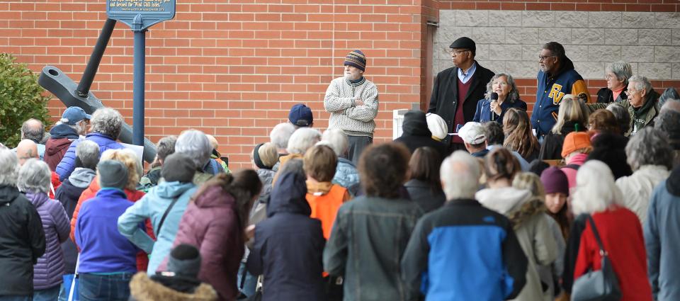 A public rally to oppose the leasing of space at Blasco Memorial Library for a university water research center is in front of the library in Erie on Nov. 4, 2023. Organizers, including Anna McCartney, upper right, with microphone, are protesting a 25-year lease agreement that was recently approved between the county and Gannon University.