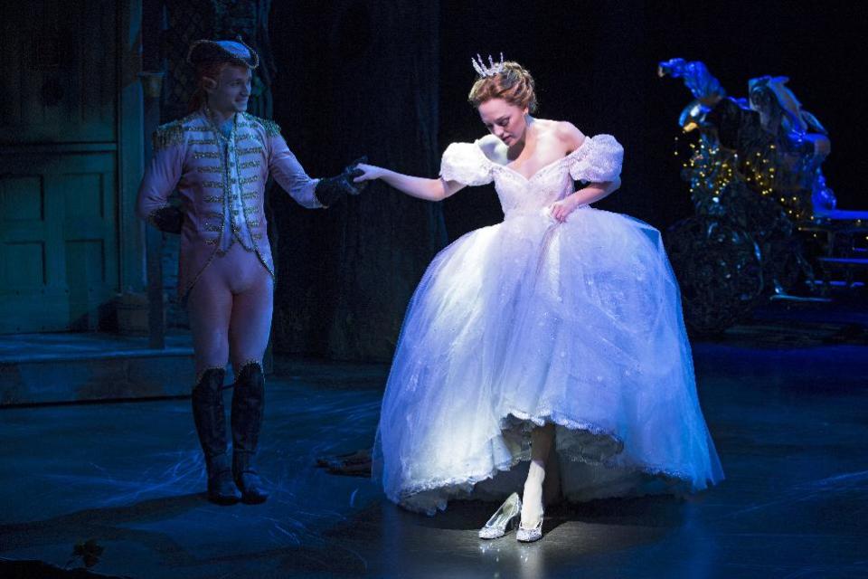 This theater image released by Sam Rudy Media Relations shows Laura Osnes as Cinderella, slipping on glass slippers designed by Stuart Weitzman, during a performance of "Rodgers + Hammerstein's Cinderella on Broadway." Weitzman knows how to make shoes that make a splash. For years, he made the “million-dollar Oscar shoes,” diamond-covered footwear that a celebrity would wear to the Academy Awards. (AP Photo/Sam Rudy Media Relations, Carol Rosegg)