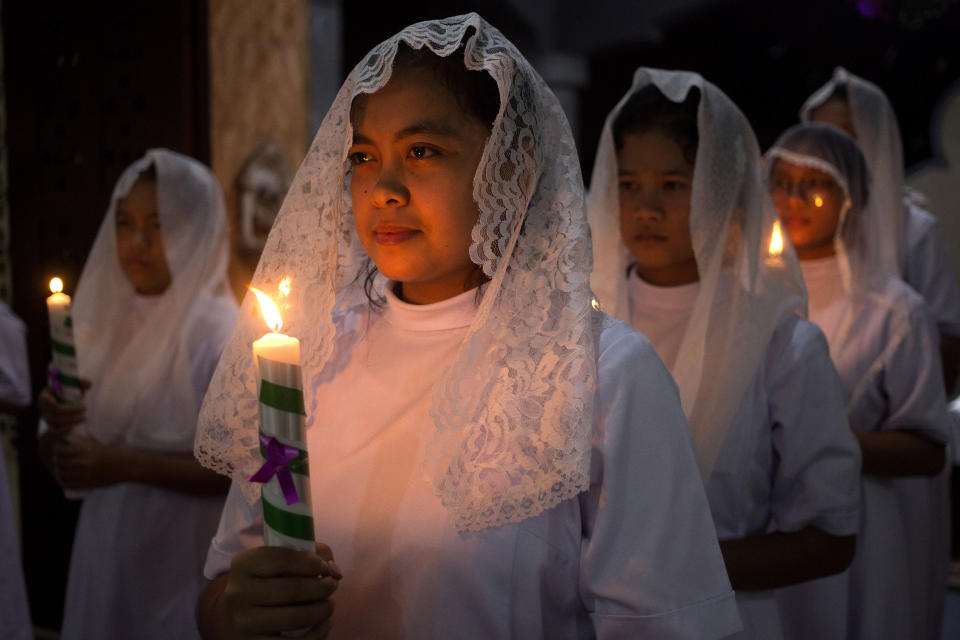 Nuns hold candles during the Christmas Eve mass at Graha Maria Annai Velangkanni Church in Medan, North Sumatra, Indonesia. Sunday, Dec. 24, 2023. (AP Photo)