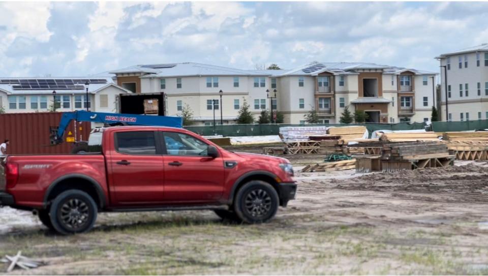 A construction crew clears land next to the Clyde Morris Landing affordable apartment and senior housing complex being built out at 1381 N. Clyde Morris Blvd. in Daytona Beach on Wednesday, July 20, 2022.