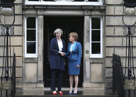 Scotland's First Minister, Nicola Sturgeon (R), greets Britain's new Prime Minister, Theresa May, as she arrives at Bute House in Edinburgh, Scotland, Britain July 15, 2016. REUTERS/Russell Cheyne