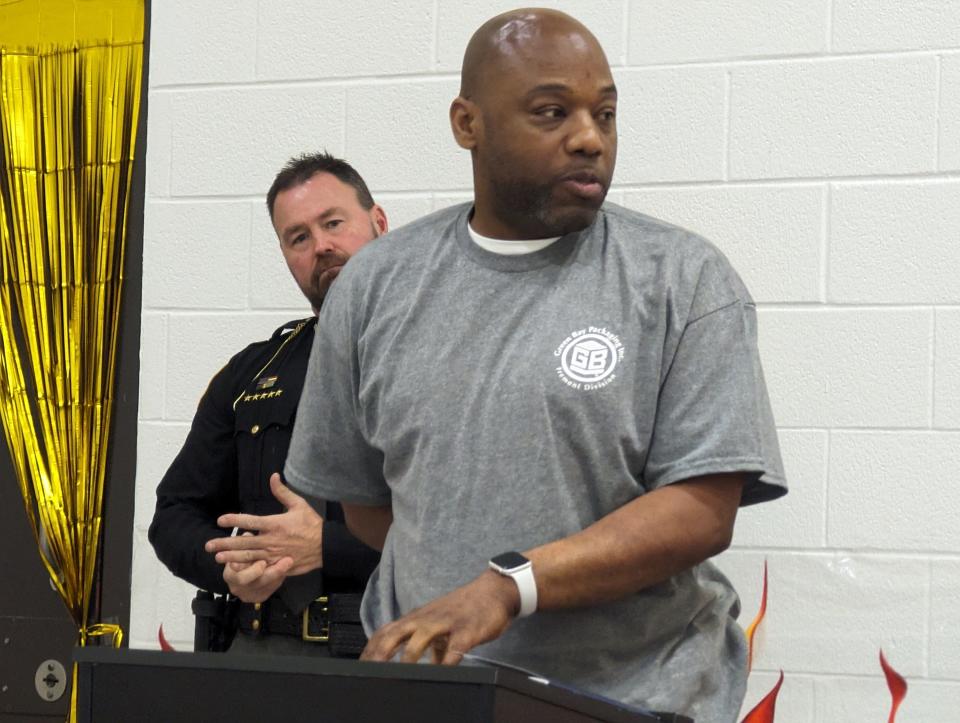 Sandusky County I.G.N.I.T.E. graduate Michael Hill returned to speak at the I.G.N.I.T.E. graduation ceremony March 20, with Sandusky County Sheriff Chris Hilton listening nearby.