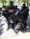 Kazakh law enforcement officers detain a man during an opposition rally in Almaty