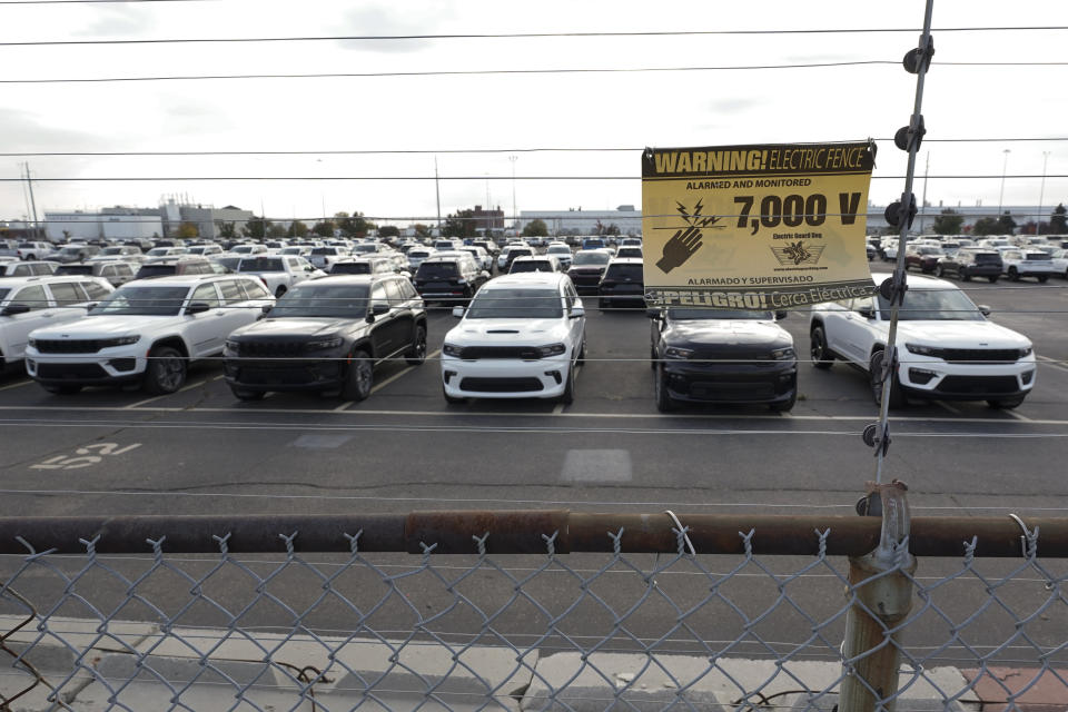 New vehicles are shown parked in storage lots near the the Stellantis Detroit Assembly Complex in Detroit, Wednesday, Oct. 5, 2022. Over the past few years, thieves have driven new vehicles from automaker storage lots and dealerships across the Detroit area. In 2018, eight vehicles were driven from what then was Fiat Chrysler's Jefferson North plant. (AP Photo/Paul Sancya)