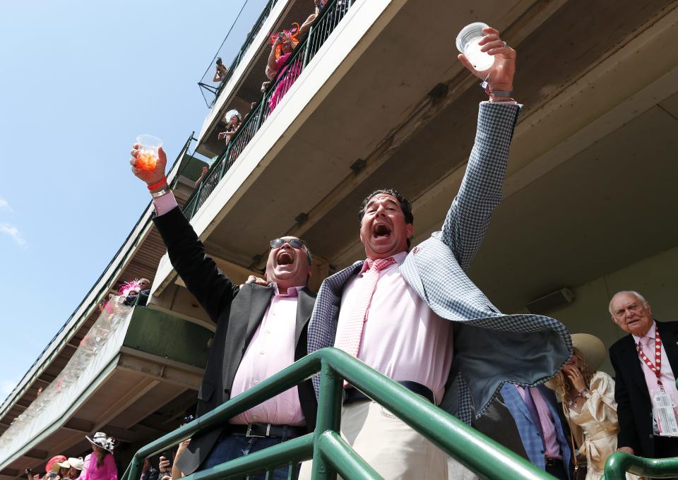 Andrew Goldberg, left, and Jason Hersh celebrated on the Millionaires Row balcony as they hit a Trifecta on Race #6 on Oaks Day at Churchill Downs in Louisville, Ky. on May 6, 2022.  They are from Philadelphia and this is their first visit to the Kentucky Derby.