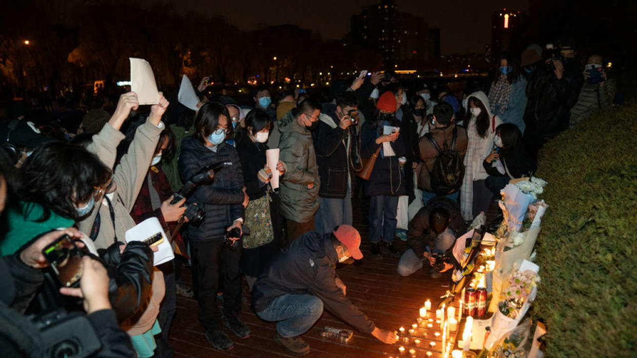 BEIJING, CHINA - NOVEMBER 27: Demonstrators light candles during a vigil to mourn the victims of the Urumqi fire in Beijing, China, on Sunday, November 27, 2022. (Photo by Stringer/Anadolu Agency via Getty Images)