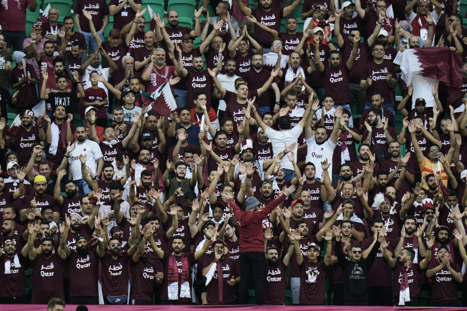 Qatar fans cheer before the World Cup group A soccer match between Qatar and Senegal, at the Al Thumama Stadium in Doha, Qatar, Friday, Nov. 25, 2022. (AP Photo/Hassan Ammar)