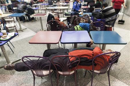 People wait for their delayed flights at LaGuardia Airport in New York January 3, 2014. REUTERS/Zoran Milich