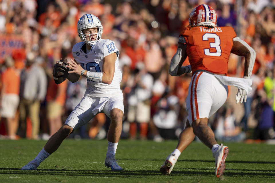 FILE - Clemson defensive end Xavier Thomas (3) pressures North Carolina quarterback Drake Maye (10) during the first half of an NCAA college football game Saturday, Nov. 18, 2023, in Clemson, S.C. Maye has been one of the big names in college football over the last two seasons and most draft pundits predict the Charlotte-area kid will be among the top 10 players selected in April's NFL draft. (AP Photo/Jacob Kupferman, File)