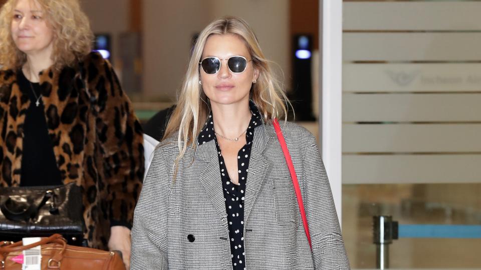 The supermodel touched down in South Korea in travel-friendly cowboy boots.