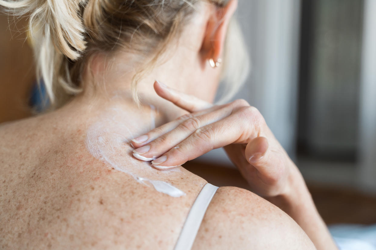 Middle-aged woman using hormone gel on her skin, hormone replacement therapy