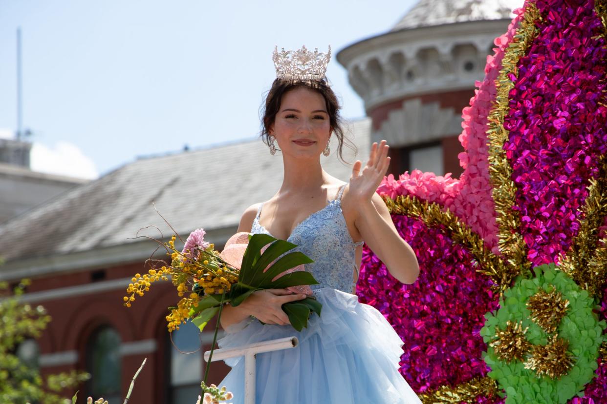 North Carolina Azalea Festival Princess Avery Braithwaite waves while passing Thalian Hall during the 2023 North Carolina Azalea Festival Parade in Wilmington, North Carolina.