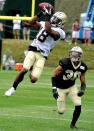 New Orleans Saints wide receiver Charles Hawkins (18) catches the ball over defensive back Trevin Wade (30) during NFL football training camp in White Sulphur Springs, W. Va., Sunday, July 27, 2014. (AP Photo/Chris Tilley)