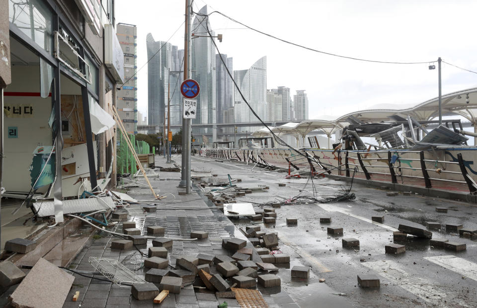 Debris caused by Typhoon Hinnamnor are seen at a waterfront park in Busan, South Korea, Tuesday, Sept. 6, 2022. The most powerful typhoon to hit South Korea in years battered its southern region Tuesday, dumping almost a meter (3 feet) of rain, destroying roads and felling power lines, leaving 20,000 homes without electricity as thousands of people fled to safer ground.(Sohn Hyung-joo/Yonhap via AP)