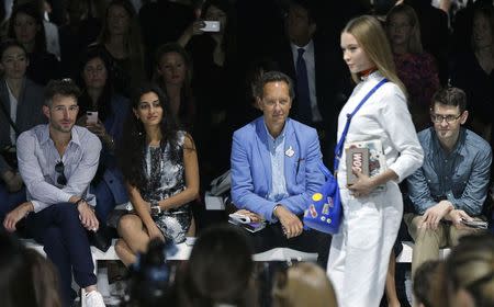 Actor Richard E. Grant (C) watches the presentation of the Anya Hindmarch Spring/Summer 2015 collection during London Fashion Week September 16, 2014. REUTERS/Suzanne Plunkett