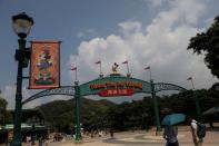 Visitors walk past the entrance to Hong Kong Disneyland in Hong Kong