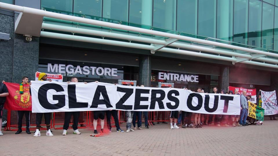 Manchester United fans gather outside of Old Trafford as they protest against the Glazer family's ownership of the club (PA)